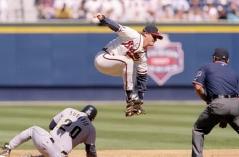 30 Sep 1997: Infielder Jeff Blauser of the Atlanta Braves (center) and catcher Tony Eusebio of the Houston Astros in action during a game at Turner Field in Atlanta, Georgia. The Braves won the game, 2-1.