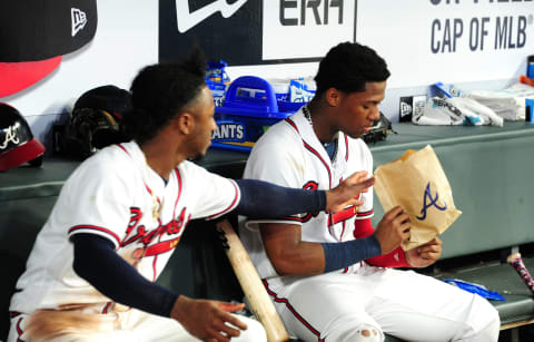 ATLANTA, GA – SEPTEMBER 20: Ozzie Albies #1 (L) and Ronald Acuna, Jr. #13 of the Atlanta Braves battle for a bag of popcorn during the bottom of the eighth inning against the Philadelphia Phillies at SunTrust Park on September 20, 2018 in Atlanta, Georgia. (Photo by Scott Cunningham/Getty Images)