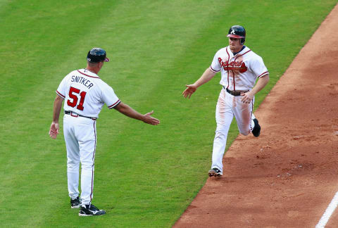 Atlanta Braves third base coach Brian Snitker acknowledging a Brooks Conrad homer. (Photo by Kevin C. Cox/Getty Images)