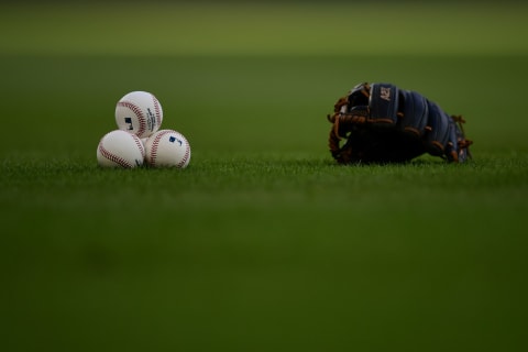 Baseballs and a glove on the field before Atlanta Braves at Truist Park on September 9, 2021 in Atlanta, Georgia. (Photo by Adam Hagy/Getty Images)