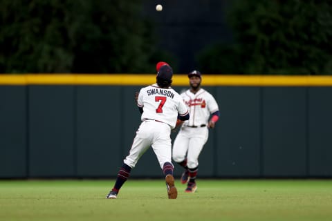 Dansby Swanson of the Atlanta Braves makes an exceptional defensive play in the NLDS. (Photo by Patrick Smith/Getty Images)