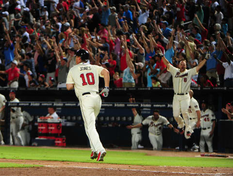 ATLANTA, GA - SEPTEMBER 2: David Ross #8 celebrates in the background as Chipper Jones #10 of the Atlanta Braves runs the bases after hitting a three-run walk-off home run against the Philadelphia Phillies at Turner Field on September 2 2012 in Atlanta, Georgia. (Photo by Scott Cunningham/Getty Images)