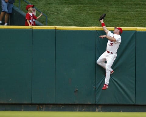 ST. LOUIS – JULY 6: Jim Edmonds #15 of the St. Louis Cardinals robs Adam Dunn #44 of the Cincinnati Reds of a home run in the second inning July 6, 2004 at Busch Stadium in St. Louis, Missouri. (Photo by Elsa/Getty Images)