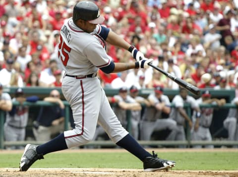 ST. LOUIS – AUGUST 6: Outfielder Andruw  Jones #25 of the Atlanta Braves hits a grand-slam home run against the St. Louis Cardinals on August 6, 2005 at Busch Stadium in St. Louis, Missouri. The Braves defeated the Cardinals 8-1. (Photo by Dilip Vishwanat/Getty Images)