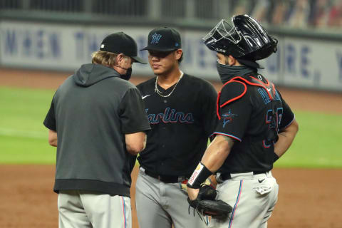 Marlins relief pitcher Jordan Yamamoto talks with pitching coach Mel Stottlemye and catcher Jorge Alfaro after a homer by Atlanta Braves OF Adam Duvall. Mandatory Credit: Jason Getz-USA TODAY Sports