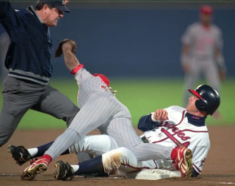 Reds’ third baseman Jeff Branson falls over Atlanta baserunner Chipper Jones. (Cincinnati Enquirer Photo By Craig Ruttle)