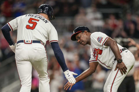 Atlanta Braves first baseman Freddie Freeman shakes hands with third base coach Ron Washington after hitting a home run. Mandatory Credit: Dale Zanine-USA TODAY Sports