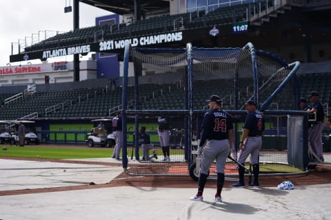 Atlanta Braves outfielder Adam Duvall (14) stands near the batting cage with bench coach Walt Weiss (4) during spring training work outs at Cool Today Park. Mandatory Credit: Jasen Vinlove-USA TODAY Sports