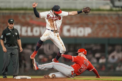 Braves shortstop Dansby Swanson (7) has to jump over a sliding Los Angeles Angels first baseman Jared Walsh (20). Mandatory Credit: Dale Zanine-USA TODAY Sports