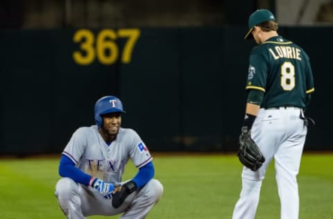 Apr 18, 2017; Oakland, CA, USA; Texas Rangers left fielder Jurickson Profar (19) smiles after reaching second base against Oakland Athletics second baseman Jed Lowrie (8) on a passed ball during the sixth inning at Oakland Coliseum. Mandatory Credit: Kelley L Cox-USA TODAY Sports