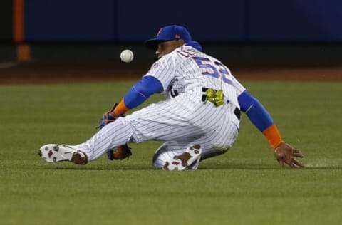 Apr 19, 2017; New York City, NY, USA; A ball hit by Philadelphia Phillies right fielder Michael Saunders (not pictured) drops in front of New York Mets left fielder Yoenis Cespedes (52) in the eighth inning at Citi Field. Mandatory Credit: Noah K. Murray-USA TODAY Sports