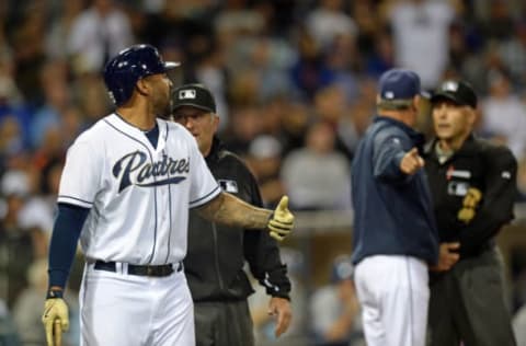 Jun 1, 2015; San Diego, CA, USA; San Diego Padres right fielder Matt Kemp (left) is walked toward the dugout by umpire Dale Scott (center, left) as manager Bud Black (center, right) continues to argue with umpire Dan Iassogna (58) after both he and Kemp were ejected by umpire Dan Iassogna (right, background) during the eighth inning against the New York Mets at Petco Park. Mandatory Credit: Jake Roth-USA TODAY Sports