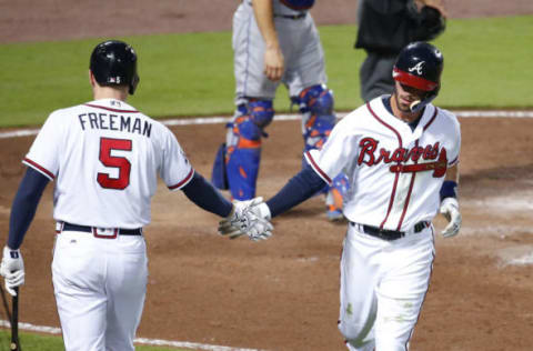 Sep 9, 2016; Atlanta, GA, USA; Atlanta Braves shortstop Dansby Swanson (2) celebrates a run with first baseman Freddie Freeman (5) off of a RBI single by third baseman Adonis Garcia (not pictured) in the fifth inning of their game against the New York Mets at Turner Field. Mandatory Credit: Jason Getz-USA TODAY Sports