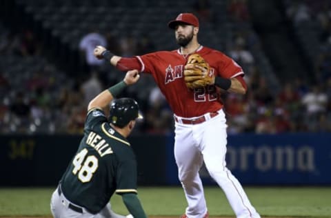 Sep 27, 2016; Anaheim, CA, USA; Los Angeles Angels infielder Kaleb Cowart (22) turns a double play over Oakland Athletics third baseman Ryon Healy (48) in the fourth inning during the game at Angel Stadium of Anaheim. Mandatory Credit: Richard Mackson-USA TODAY Sports