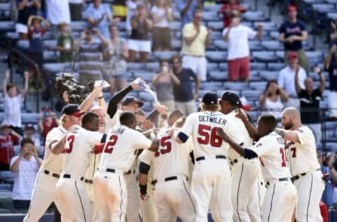 Aug 16, 2015; Atlanta, GA, USA; Atlanta Braves center fielder Cameron Maybin (25) (in the pile) reacts with team mates after hitting a lead off walk off home run to defeat the Arizona Diamondbacks during the tenth inning at Turner Field. The Braves defeated the Diamondbacks 2-1 in ten innings. Mandatory Credit: Dale Zanine-USA TODAY Sports