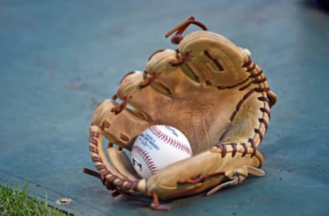 Oct 16, 2015; Kansas City, MO, USA; A general view of a glove and baseball during batting practice prior to game one of the ALCS between the Kansas City Royals and the Toronto Blue Jays at Kauffman Stadium. Mandatory Credit: Peter G. Aiken-USA TODAY Sports