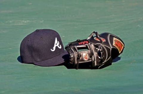 May 14, 2016; Kansas City, MO, USA; A general view of a Atlanta Braves cap and glove on the field prior to a game against the Kansas City Royals at Kauffman Stadium. Mandatory Credit: Peter G. Aiken-USA TODAY Sports