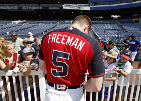 Jul 15, 2016; Atlanta, GA, USA; Atlanta Braves first baseman Freddie Freeman (5) signs autographs for fans before their game against the Colorado Rockies at Turner Field. Mandatory Credit: Jason Getz-USA TODAY Sports