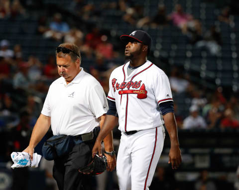 Jul 15, 2016; Atlanta, GA, USA; Atlanta Braves relief pitcher Arodys Vizcaino (38) walks off of the field with assistant athletic trainer Jim Lovell after injuring himself in the eighth inning of their game against the Colorado Rockies at Turner Field. The Rockies won 11-2. Mandatory Credit: Jason Getz-USA TODAY Sports