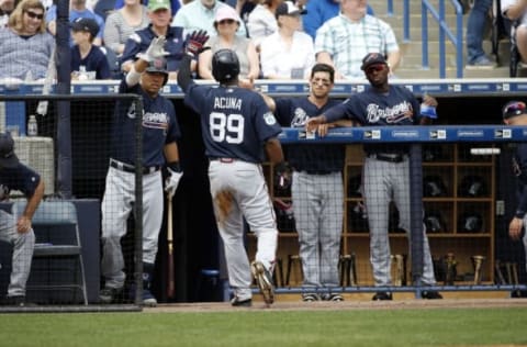 Mar 12, 2017; Tampa, FL, USA; Atlanta Braves center fielder Ronald Acuna (89) is congratulated by catcher Kurt Suzuki (24) and teammates after he scored during the first inning against the New York Yankees at George M. Steinbrenner Field. Mandatory Credit: Kim Klement-USA TODAY Sports