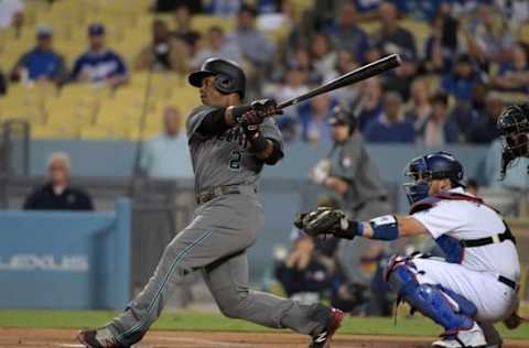 Jean Segura (2) bats as Los Angeles Dodgers catcher Yasmani Grandal (9) watches. (Kirby Lee-USA TODAY Sports)