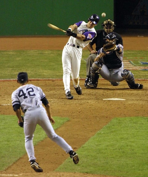 Arizona Diamondbacks left fielder Luis Gonzalez hits his RBI single in the bottom of the 9th inning off New York Yankees relief pitcher Mariano Rivera (#42) which won Game 7 of the World Series for the Diamondbacks in Phoenix 04 November 2001. The Diamondbacks defeated the New York Yankees 3-2, winning the series four games to three and become the 2001 world champions. AFP PHOTO Mike NELSON (Photo by MIKE NELSON / AFP) (Photo credit should read MIKE NELSON/AFP via Getty Images)