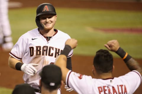 PHOENIX, ARIZONA – SEPTEMBER 25: Pavin Smith #26 of the Arizona Diamondbacks is congratulated by David Peralta #6 after hitting a solo home run against the Colorado Rockies in the fifth inning during game two of a doubleheader at Chase Field on September 25, 2020, in Phoenix, Arizona. (Photo by Christian Petersen/Getty Images)