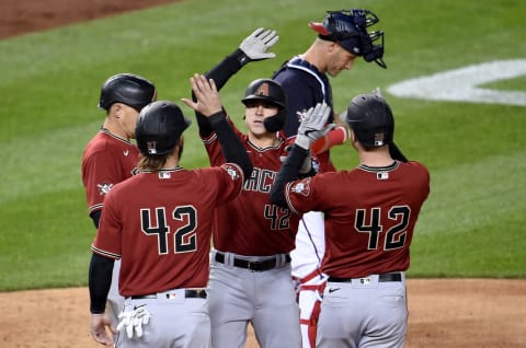 WASHINGTON, DC – APRIL 15: Andrew Young #15 of the Arizona Diamondbacks celebrates with Nick Ahmed #13, Pavin Smith #26, and Wyatt Mathisen #27 after hitting a grand slam in the second inning against the Washington Nationals at Nationals Park on April 15, 2021, in Washington, DC. All players are wearing the number 42 in honor of Jackie Robinson Day. (Photo by G Fiume/Getty Images)