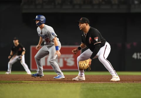 PHOENIX, ARIZONA – JULY 31: Asdrubal Cabrera #14 of the Arizona Diamondbacks gets ready to make a play at first base against the Los Angeles Dodgers at Chase Field on July 31, 2021 in Phoenix, Arizona. (Photo by Norm Hall/Getty Images)