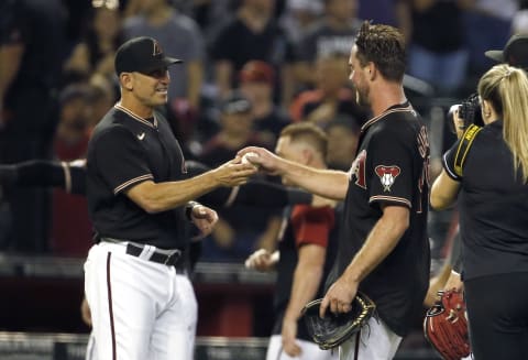 PHOENIX, ARIZONA – AUGUST 14: Starting pitcher Tyler Gilbert #49 of the Arizona Diamondbacks receives the game ball from manager Torey Lovullo #17 of the Diamondbacks following his no hitter against the San Diego Padres during the MLB game at Chase Field on August 14, 2021 in Phoenix, Arizona. The Diamondbacks defeated the Padres 7-0. (Photo by Ralph Freso/Getty Images)