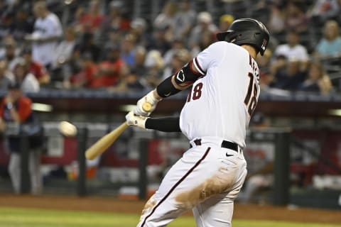 PHOENIX, ARIZONA – SEPTEMBER 23: Carson Kelly #18 of the Arizona Diamondbacks hits a three-run home run during the seventh inning of the MLB game against the Atlanta Braves at Chase Field on September 23, 2021 in Phoenix, Arizona. (Photo by Kelsey Grant/Getty Images)