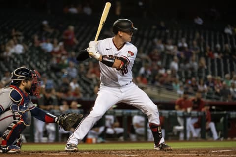 PHOENIX, AZ – SEPTEMBER 23: Carson Kelly #18 of the Arizona Diamondbacks bats against the Atlanta Braves during the second inning of the MLB game at Chase Field on September 23, 2021, in Phoenix, Arizona. (Photo by Kelsey Grant/Getty Images)