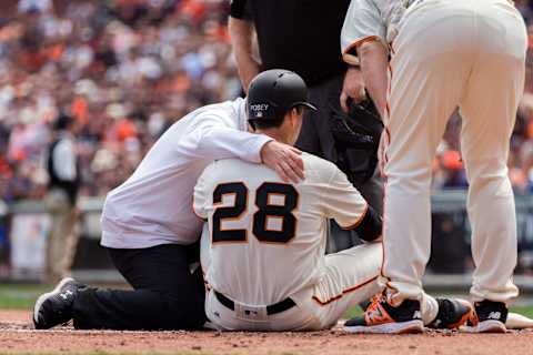 Apr 10, 2017; San Francisco, CA, USA; San Francisco Giants catcher Buster Posey (28) is hit by the ball and leaves the game against the Arizona Diamondbacks in the first inning at AT&T Park. Mandatory Credit: John Hefti-USA TODAY Sports