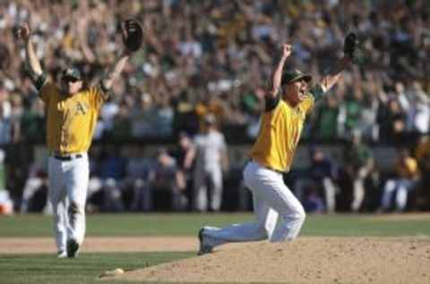 October 3, 2012; Oakland, CA, USA; Oakland Athletics relief pitcher Grant Balfour (50) and first baseman Brandon Moss (37) celebrate after the win against the Texas Rangers at O.co Coliseum. The Oakland Athletics defeated the Texas Rangers 12-5 to become the American League west champions. Mandatory Credit: Kelley L Cox-USA TODAY Sports