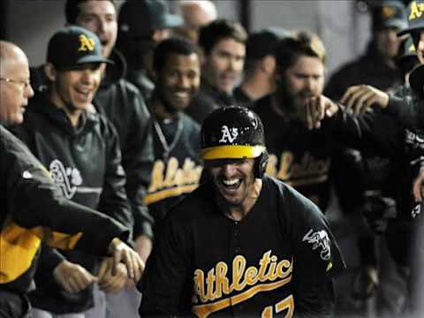 Jun 6, 2013; Chicago, IL, USA; Oakland Athletics shortstop Adam Rosales (17) is greeted by teammates in the dugout after hitting the go ahead home run during the tenth inning against the Chicago White Sox at U.S. Cellular Field. The Oakland Athletics defeated the Chicago White Sox 5-4 in ten innings. Mandatory Credit: David Banks-USA TODAY Sports