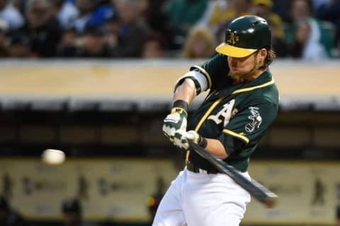 May 30, 2015; Oakland, CA, USA; Oakland Athletics right fielder Josh Reddick (22) hits a RBI-single to score shortstop Marcus Semien (10, not pictured) against the New York Yankees during the third inning at O.co Coliseum. Mandatory Credit: Kyle Terada-USA TODAY Sports