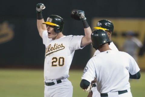 Sep 22, 2015; Oakland, CA, USA; Oakland Athletics first baseman Mark Canha (20) celebrates after hitting an RBI single against the Texas Rangers during the second inning of the game against the Texas Rangers at O.co Coliseum. Mandatory Credit: Ed Szczepanski-USA TODAY Sports