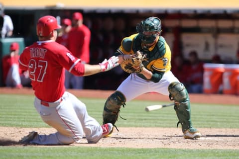 Sep 2, 2015; Oakland, CA, USA; Oakland Athletics catcher Stephen Vogt (21) makes the out against Los Angeles Angels center fielder Mike Trout (27) during the ninth inning at O.co Coliseum. The Los Angeles Angels defeated the Oakland Athletics 9-4. Mandatory Credit: Kelley L Cox-USA TODAY Sports