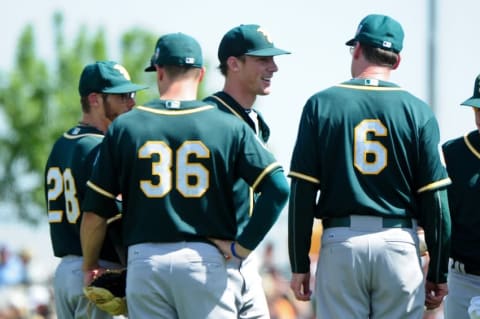 Mar 21, 2016; Scottsdale, AZ, USA; Oakland Athletics starting pitcher Chris Bassitt (40) talks with manager Bob Melvin (6) and third baseman Matt Chapman (36) and second baseman Eric Sogard (28) after being hit by a ball off the bat of San Francisco Giants Miguel Olivio (not pictured) during the second inning at Scottsdale Stadium. Mandatory Credit: Matt Kartozian-USA TODAY Sports