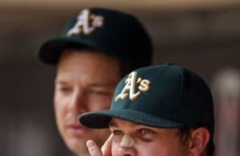 Jul 6, 2016; Minneapolis, MN, USA; Oakland Athletics starting pitcher Sonny Gray (54) talks with starting pitcher Rich Hill (18) after leaving the game against the Minnesota Twins after six innings at Target Field. The Twins win 4-0. Mandatory Credit: Bruce Kluckhohn-USA TODAY Sports