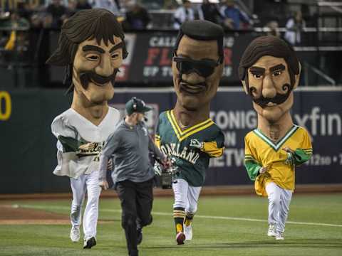 May 19, 2016; Oakland, CA, USA; The traditional Hall of Fame Race at the end of the sixth inning, featuring runners in the costumes of former A’s legends Dennis Eckersley (L), Rickey Henderson (C) and Rollie Fingers (R), during the baseball game between the New York Yankees and Oakland Athletics at Oakland Coliseum. Mandatory Credit: Kenny Karst-USA TODAY Sports