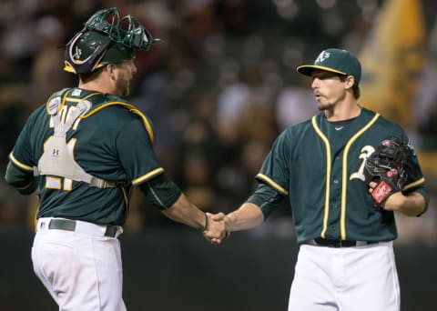 Jun 29, 2016; Oakland, CA, USA; Oakland Athletics relief pitcher Ryan Dull (66) is congratulated by catcher Stephen Vogt (21) after the end of the game against the San Francisco Giants at the Coliseum the Oakland Athletics defeated the San Francisco Giants 7 to 1. Mandatory Credit: Neville E. Guard-USA TODAY Sports