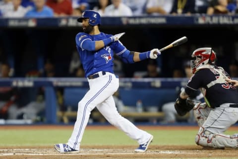 Oct 19, 2016; Toronto, Ontario, CAN; Toronto Blue Jays right fielder Jose Bautista (19) hits a single during the sixth inning against the Cleveland Indians in game five of the 2016 ALCS playoff baseball series at Rogers Centre. Mandatory Credit: John E. Sokolowski-USA TODAY Sports