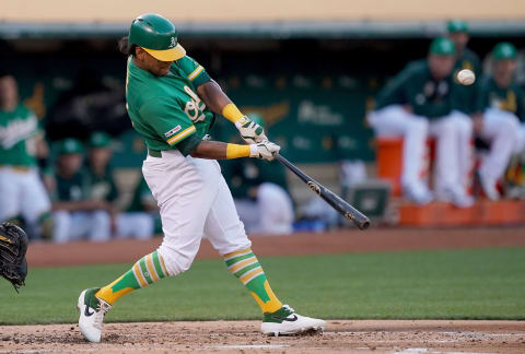 OAKLAND, CA – JULY 25: Khris Davis #2 of the Oakland Athletics hits a sacrifice fly scoring Mark Canha against the Texas Rangers in the bottom of the first inning at Ring Central Coliseum on July 25, 2019, in Oakland, California. (Photo by Thearon W. Henderson/Getty Images)