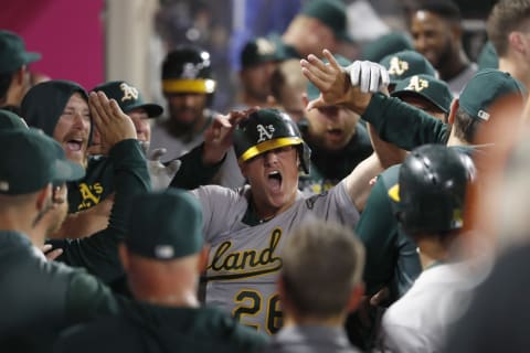 ANAHEIM, CALIFORNIA – SEPTEMBER 25: Matt Chapman #26 of the Oakland Athletics is congratulated in the dugout after hitting a two-run home run during the eighth inning of a game against the Los Angeles Angels of Anaheim at Angel Stadium of Anaheim on September 25, 2019 in Anaheim, California. (Photo by Sean M. Haffey/Getty Images)