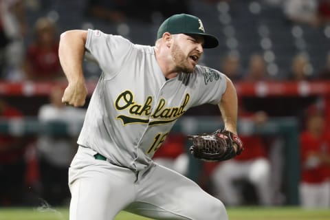 ANAHEIM, CALIFORNIA – SEPTEMBER 25: Liam Hendriks #16 of the Oakland Athletics reacts getting Kevan Smith #44 of the Los Angeles Angels of Anaheim to ground out and end a game at Angel Stadium of Anaheim on September 25, 2019, in Anaheim, California. Tthe Oakland Athletics defeated the Los Angeles Angels of Anaheim 3-2. (Photo by Sean M. Haffey/Getty Images)