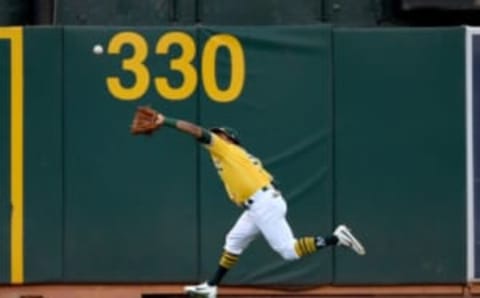 A’s left fielder Khris Davis runs to make a catch