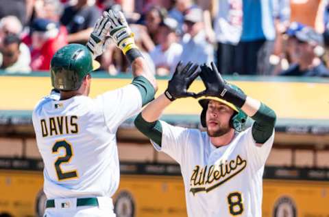 May 20, 2017; Oakland, CA, USA; Oakland Athletics left fielder Khris Davis (2) high fives second baseman Jed Lowrie (8) after batting him in on a two run home run against the Boston Red Sox during the fifth inning at Oakland Coliseum. Mandatory Credit: Kelley L Cox-USA TODAY Sports