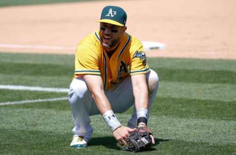 May 24, 2017; Oakland, CA, USA; Oakland Athletics third baseman Trevor Plouffe (3) reacts as Oakland Athletics designated hitter Ryon Healy (25) missed the catch to tag out Miami Marlins first baseman Justin Bour (41) during the ninth inning at Oakland Coliseum. Mandatory Credit: Stan Szeto-USA TODAY Sports