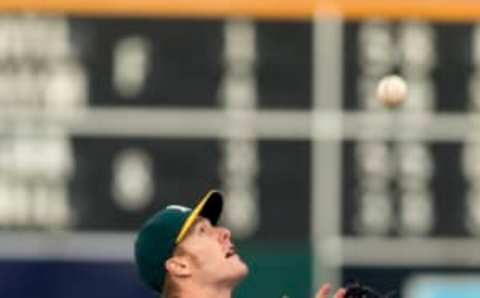 May 2, 2016; Oakland, CA, USA; Oakland Athletics first baseman Mark Canha (20) catches an infield fly ball hit by Seattle Mariners second baseman Robinson Cano (not pictured) in the first inning at the Coliseum. Mandatory Credit: Neville E. Guard-USA TODAY Sports